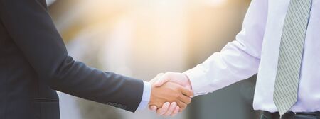 Business handshake concept. shaking hand of two businessman negotiation closing a deal city backgroundの写真素材