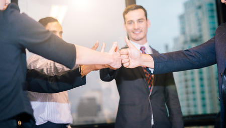 Team Business Partners Giving Thumb up Bump after Complete a deal. Successful Teamwork Partnership...