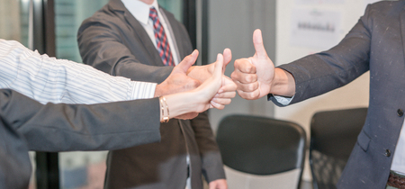 Business people give thumbs up signの写真素材