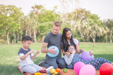 Young family with children having fun in natureの写真素材