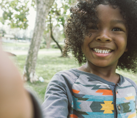 Kid taking selfie in parkの写真素材