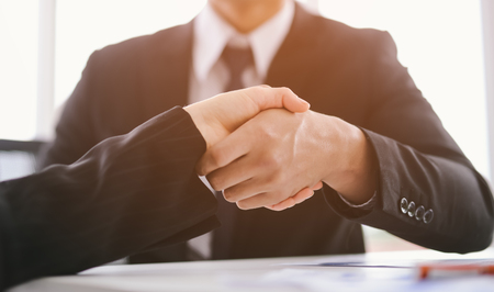 handshake business concept. business people shaking hands in office.の写真素材