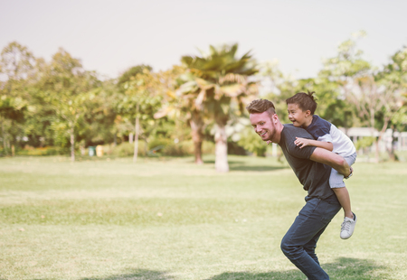 Dad and son having fun outdoors.concept of a happy family.の写真素材