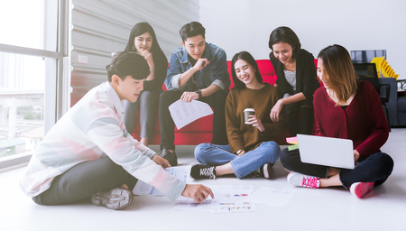 young asian teen group meeting discuss or brainstorm business strategy doing project in modern...