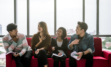 Young Asian friends group talking in officeの写真素材