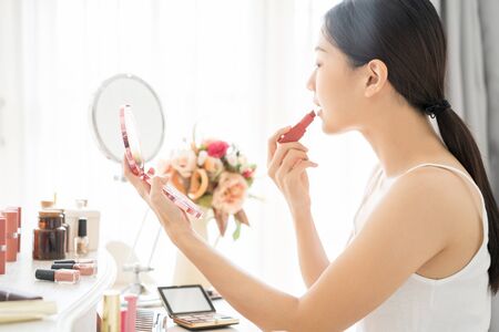 Young Asian female makeup beauty by lipstickの写真素材