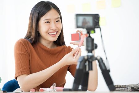 Young Asian woman recording a video for a woman beauty blogger. Makeup Tutorial