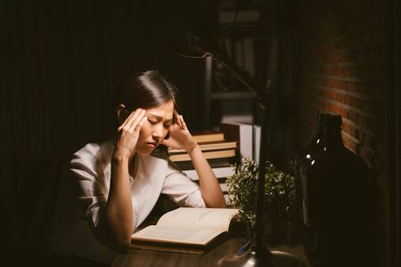 Young Asian girl stressed by the studyの写真素材