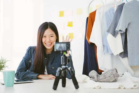 Young Asian woman recording a video for a woman fashion blogger.の写真素材