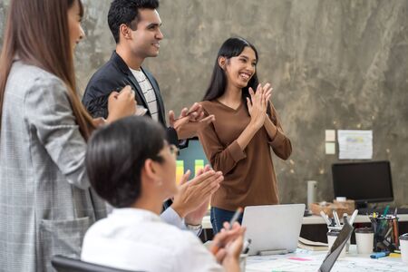 Group of Asian team creative business people clapping hands for success after finished meeting....