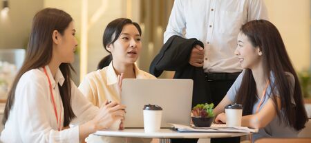 Young Asian woman and business people are meeting in office discussion with colleagues . Group of Business team working and share ideas about project to partnersの写真素材