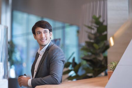 Portrait  of business man drinking coffee in office during the break.の写真素材
