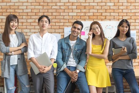 Portrait of Asian creative business team. Hipster Creative Startup Young business people in modern office.の写真素材