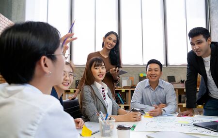 Group of Asian business people team meeting in modern office working design planning and ideas...