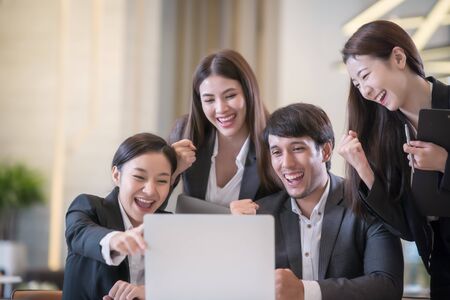 Young Asian business people are meeting in office . Group of Business team working Meeting at the screen monitorの写真素材