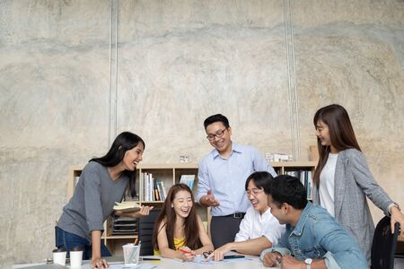 Group of Asian business people team meeting in modern office working design planning and ideas...