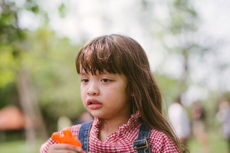little girl crying in parkの写真素材
