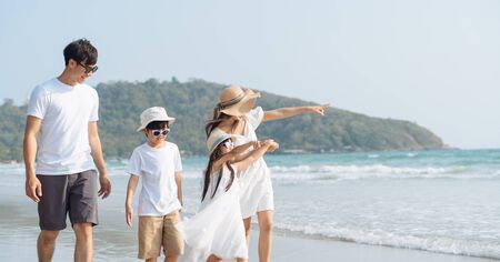 Asian Family walking at beach with kids happy vacation conceptの写真素材