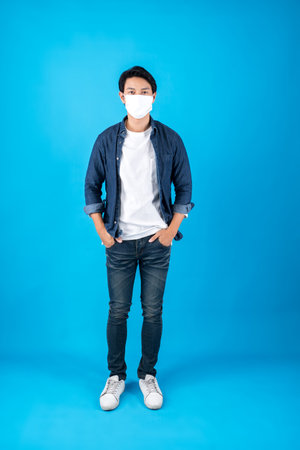Young happy Asian man wearing face maskの写真素材