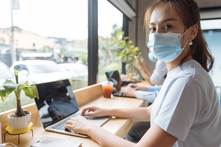 Asian people wearing mask working at coffee shopの写真素材