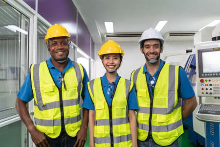 Portrait of team worker labor with machine in factory plant.の写真素材