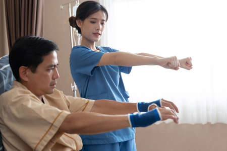 Asian nurse therapists  stretching arm muscles treatment of physiological.の写真素材
