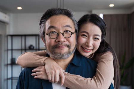 Middle-aged Asian couple smiling for the camera. Family couple portraitの写真素材