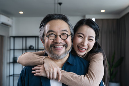 Closeup Middle-aged Asian couple smiling for the camera And look at each other. Family couple portraitの写真素材