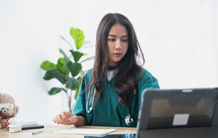 Asian Female doctor working at office desk.の写真素材