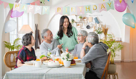 Group of Asian senior people having birthday party at home, celebrating birthday at retirement home...