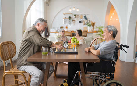 Portrait of two Asian senior men playing chess and in nursing homeの写真素材