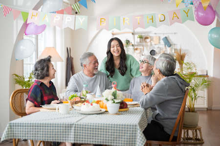 Group of Asian senior people having birthday party at home, celebrating birthday at retirement home with friendsの写真素材