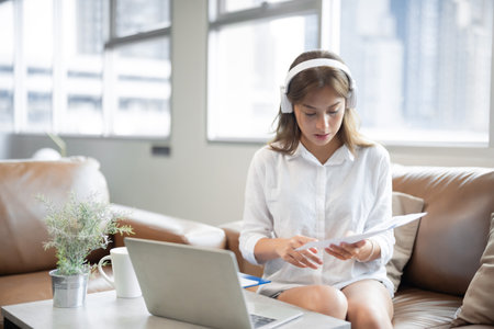 Young Asian business woman using laptop online meeting in video call conference in living room at home.の写真素材
