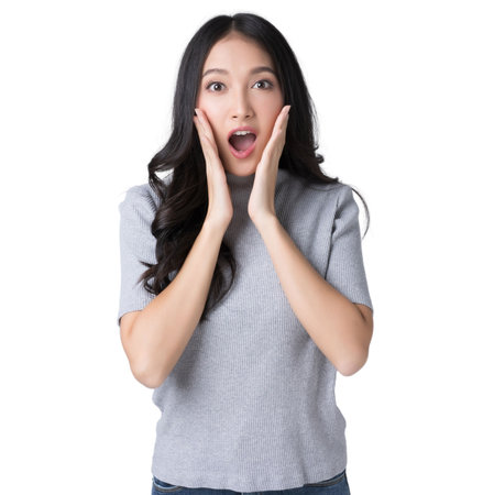 Young Asian doing a shocked surprise gesture with her hands on her face Isolate die cut on transparent backgroundの写真素材