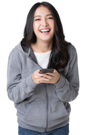 Asian woman Holding the phone smiling happily while looking at the camer Isolate die cut on transparent backgroundの写真素材