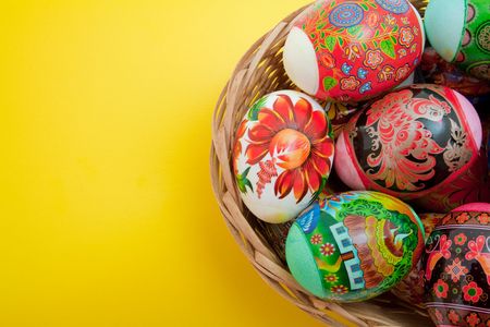 easter eggs in basket on yellow backgroundの写真素材