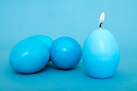 easter eggs with easter candle isolated on whiteの写真素材