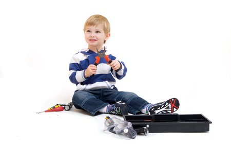 little boy playing with tools isolated on whiteの写真素材
