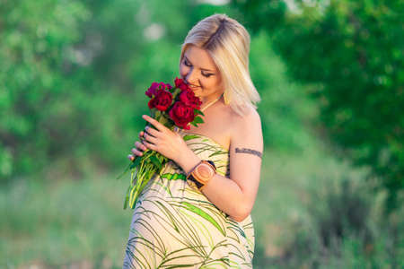 beautiful pregnant woman in sunny dayの写真素材