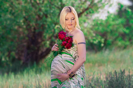 beautiful pregnant woman in sunny dayの写真素材