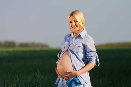 beautiful pregnant woman in sunny dayの写真素材