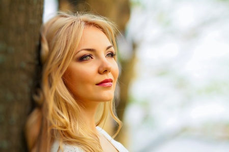 portrait of blond woman in white dress outdoorの写真素材