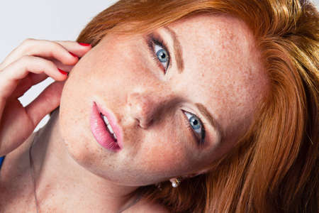 cute model in studio with red hair
