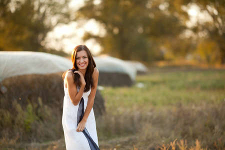 portrait of beautiful brunette young woman in countrysideの写真素材