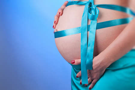 tummy of pregnant woman isolated on whiteの写真素材