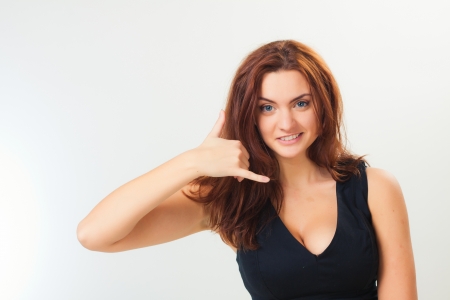 Beautiful casual young woman standing against white backgroundの写真素材