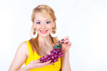 Young woman with grape over whiteの写真素材