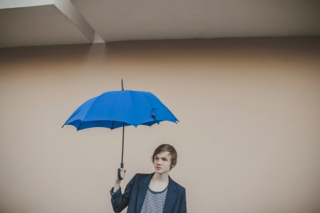 Happy young couple with umbrellaの写真素材