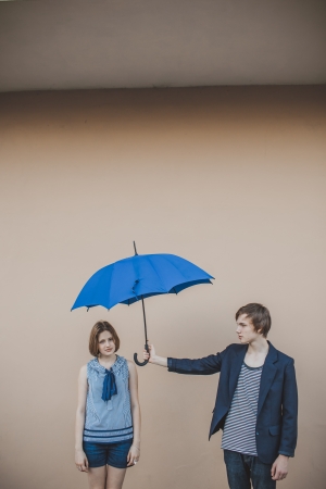 Happy young couple with umbrellaの写真素材