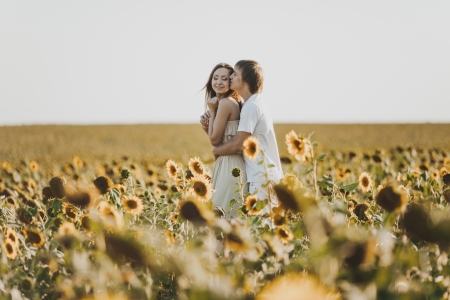 Young loving couple in fieldの写真素材